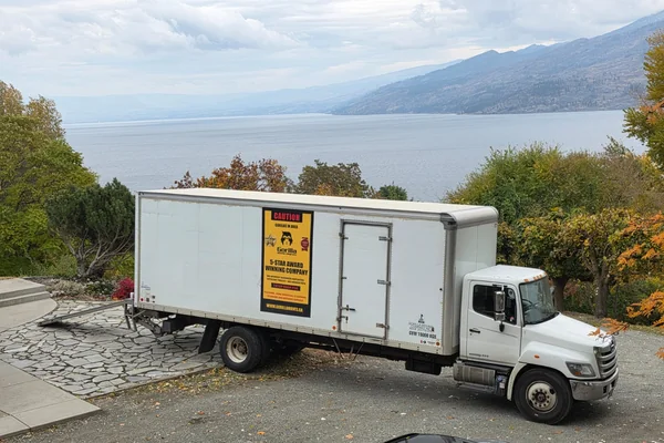 Residential movers in Langley BC loading household furniture into a moving truck